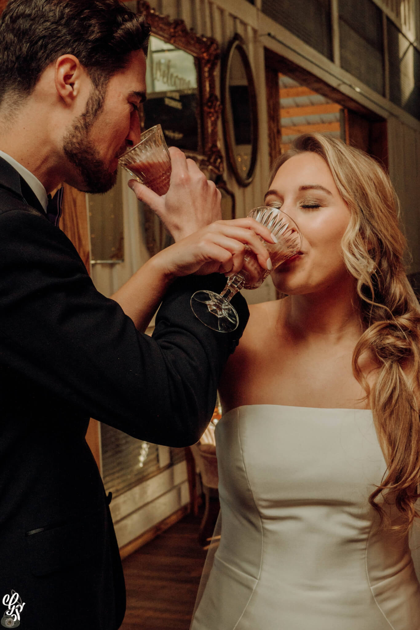 husband and wife at wedding with crossed arms enjoying a luxury craft cocktail from All Shook Up Catering