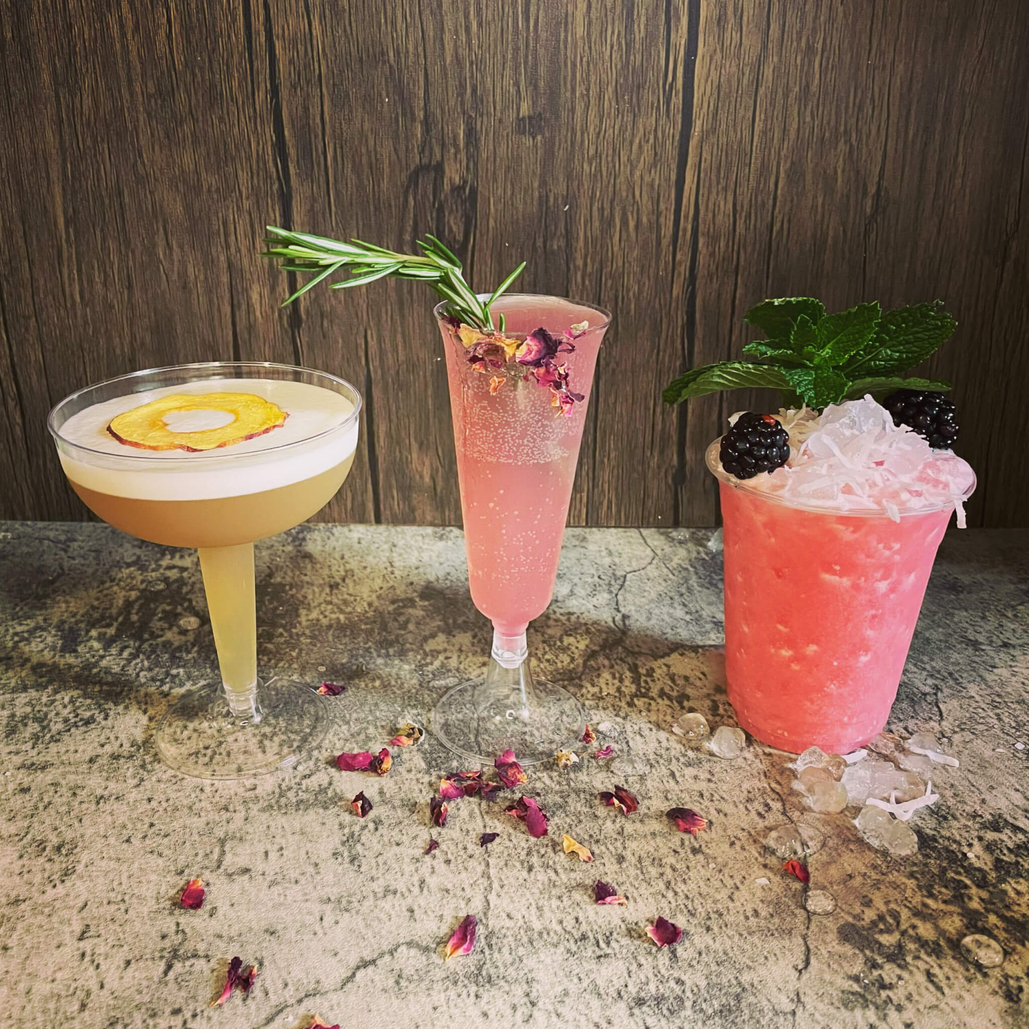 three cocktails with fresh granishes